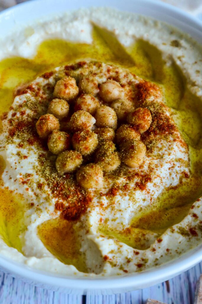 A bowl of easy hummus recipe with chickpeas on top
