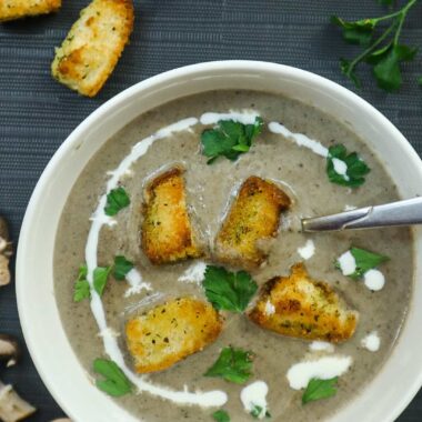 Bowl of creamy mushroom soup with croutons