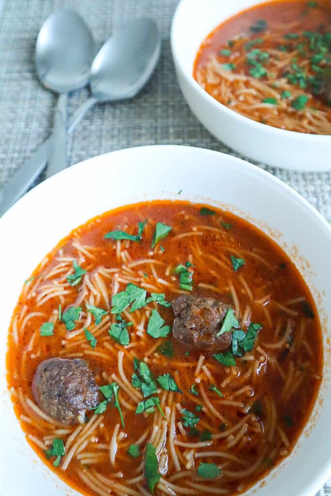A bowl of Meatball Vermicelli Soup with parsley on top 