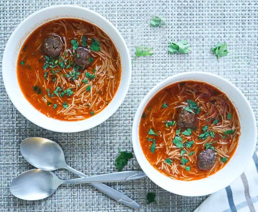 Two bowls of Meatball Vermicelli Soup with parsley on top 