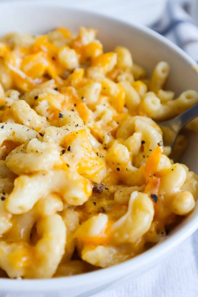 A bowl of macaroni and cheese and a baked dish