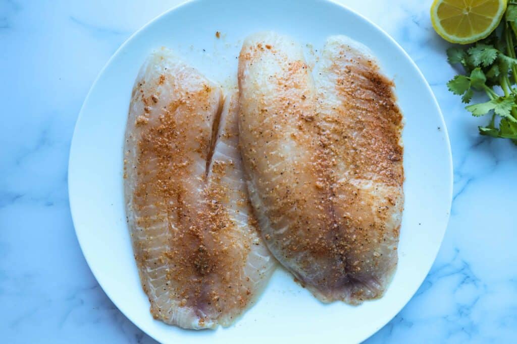 a plate of two pieces of tilapia rubbed with the spices