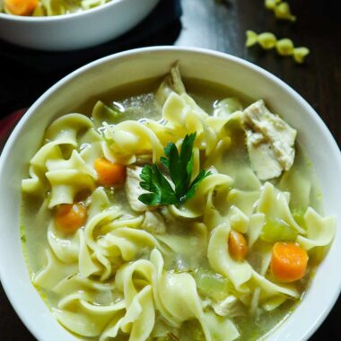 Two bowls of chicken noodle soup