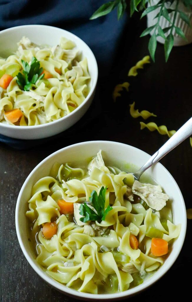 Two bowls of chicken noodle soup