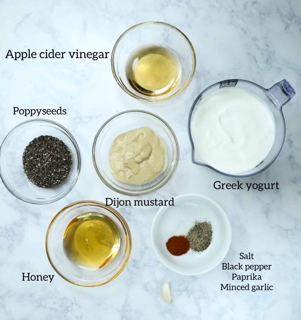 A small bowl of greek yogurt, poppyseeds, honey, vinegar, dijon mustard and spices 