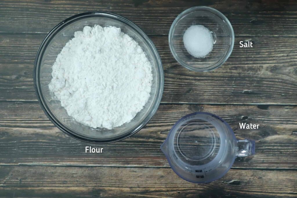A bowl of flour, salt and a cup of water