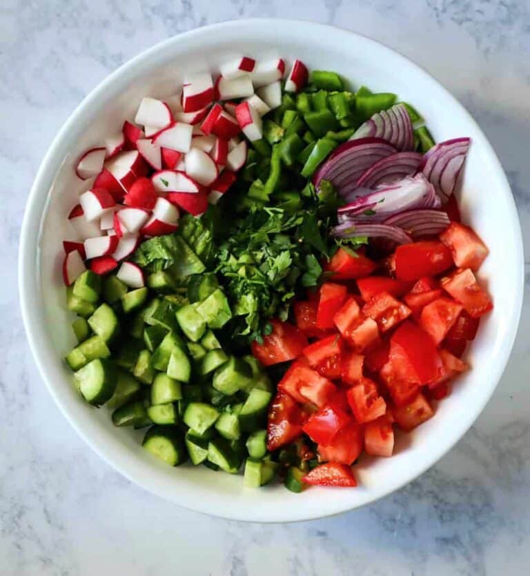 A large bowl of fattoush salad ingredients