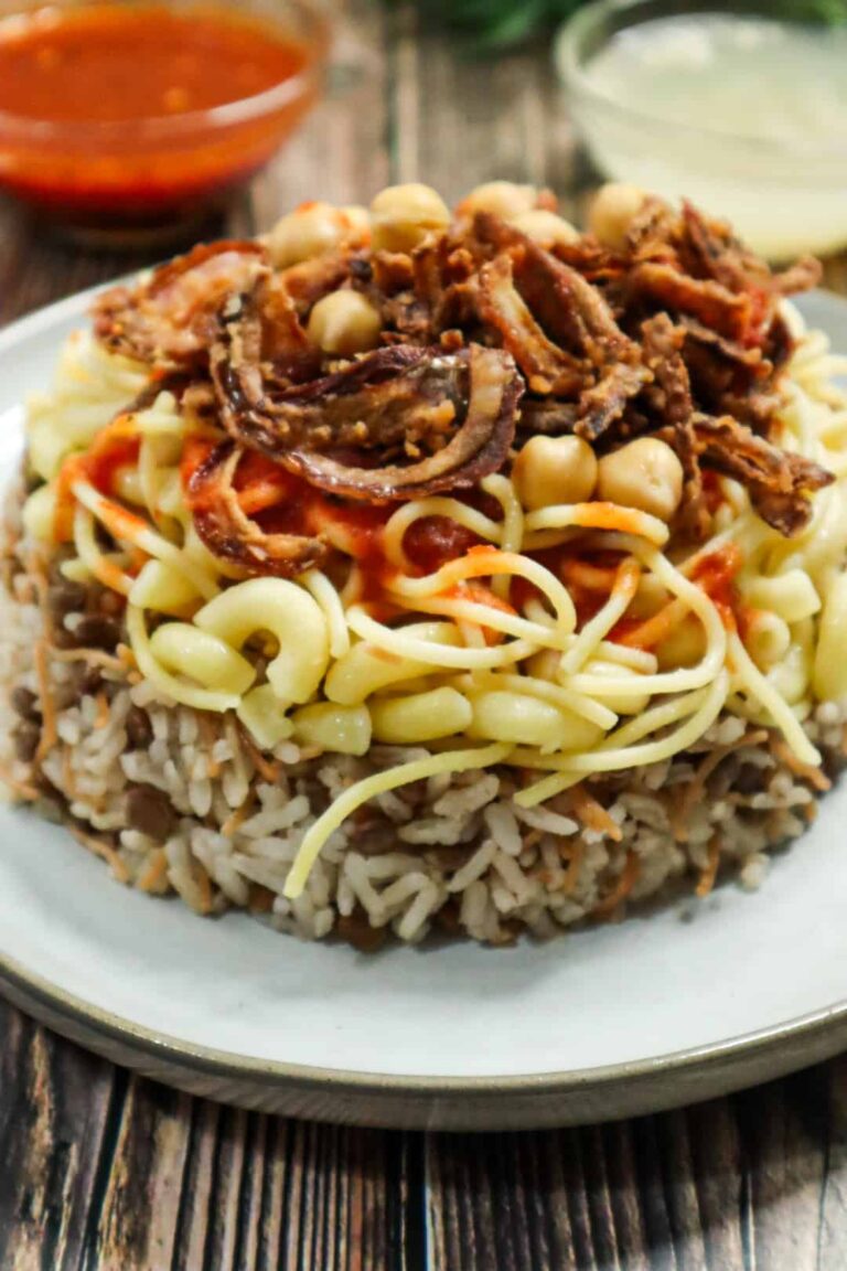 A dish of Egyptian koshari and two sauces on the side