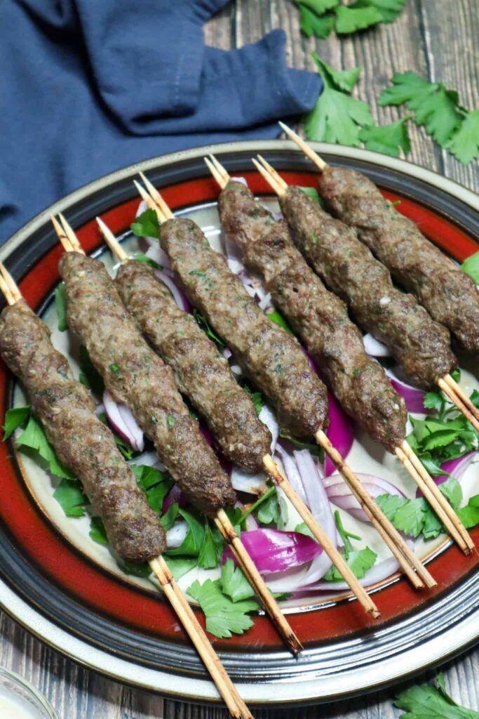 Beef Kebabs on a dish with parsley on the side